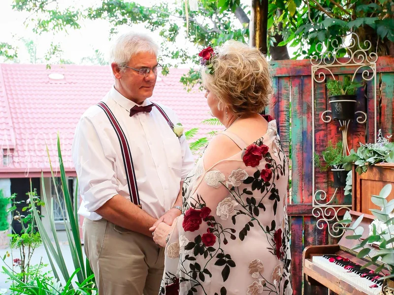 A couple exchanging vows during a vow renewal at Anelli's Tea Garden